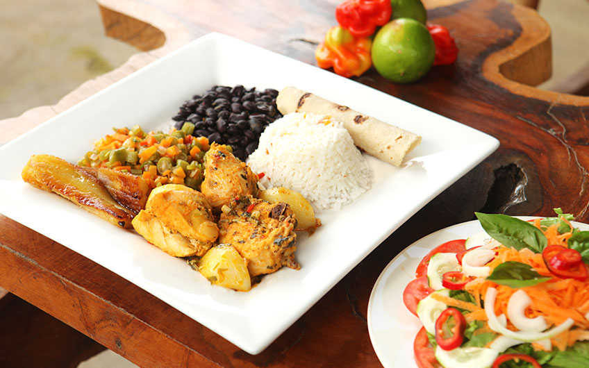 A delicious casado, the typical Costa Rican lunch. Rice, beans, bananas, chicken, vegetables and salad make up the dish.